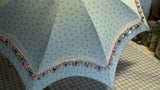 Fashion accessory umbrella, with lace & buttons, on simple all-over fabric pattern