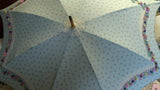 Fashion accessory umbrella, with lace & buttons, on simple all-over fabric pattern